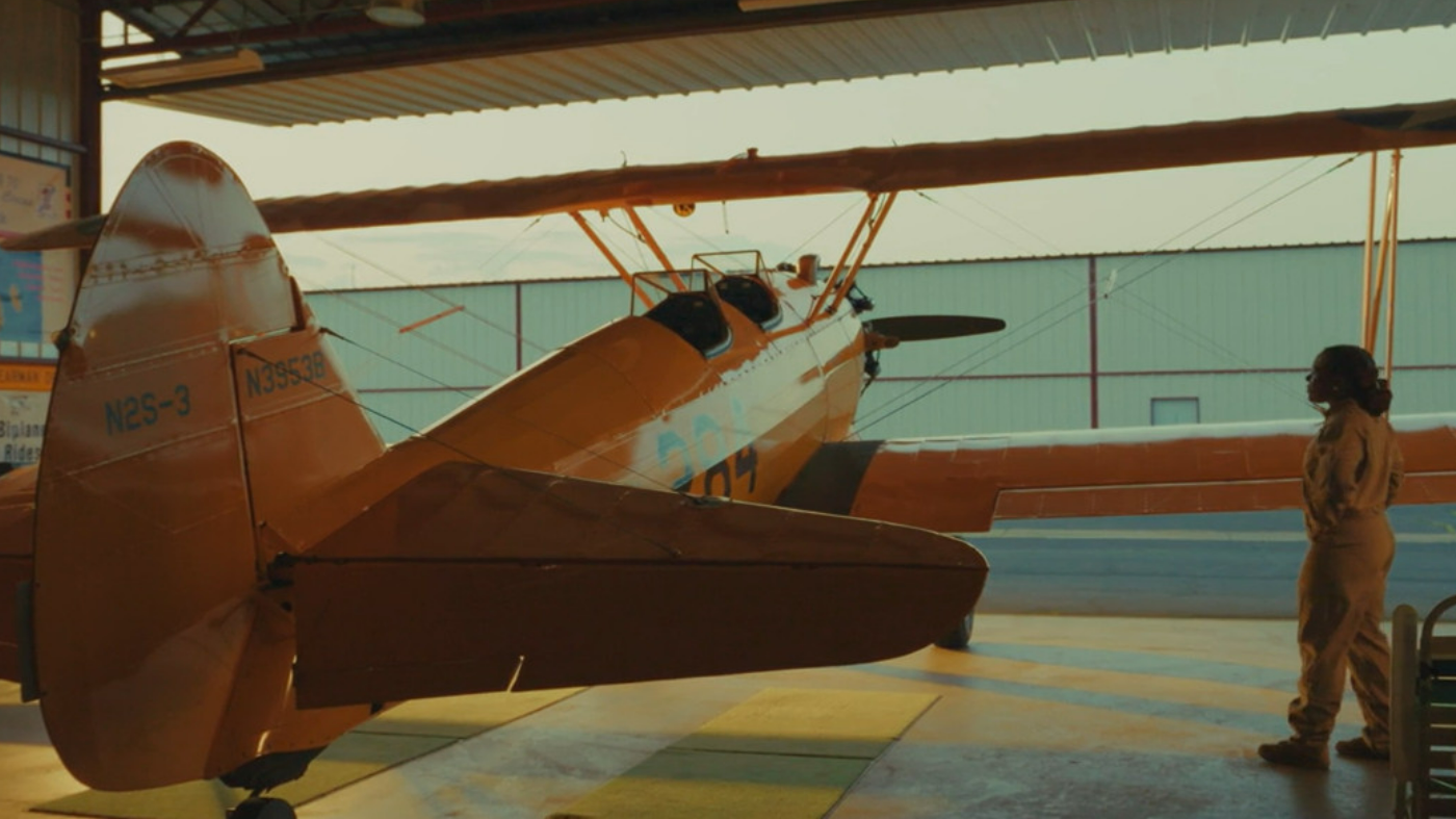 A screenshot from the new VA Careers PSA, showing a female Veteran boarding a biplane.