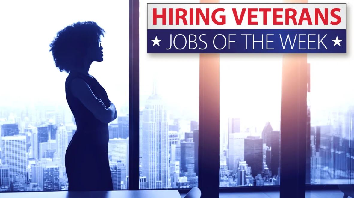 Woman looking out window of high rise building. Veteran jobs of the week.