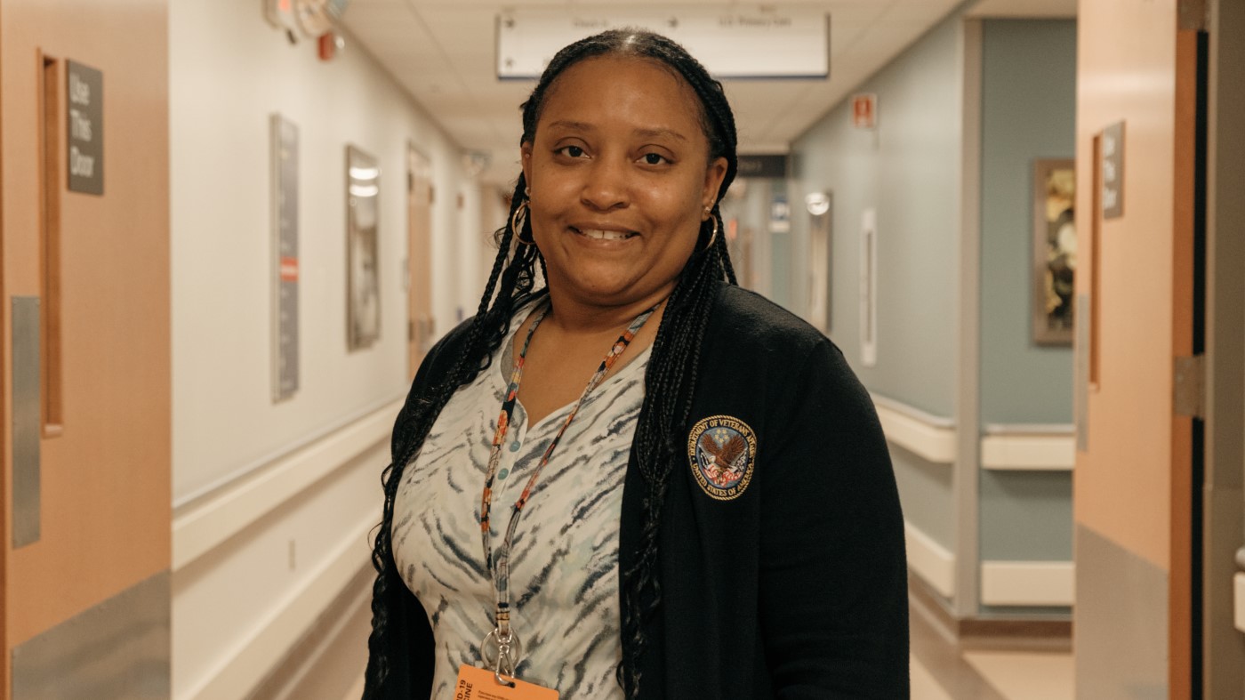 A Black female VA employee in a hallway.