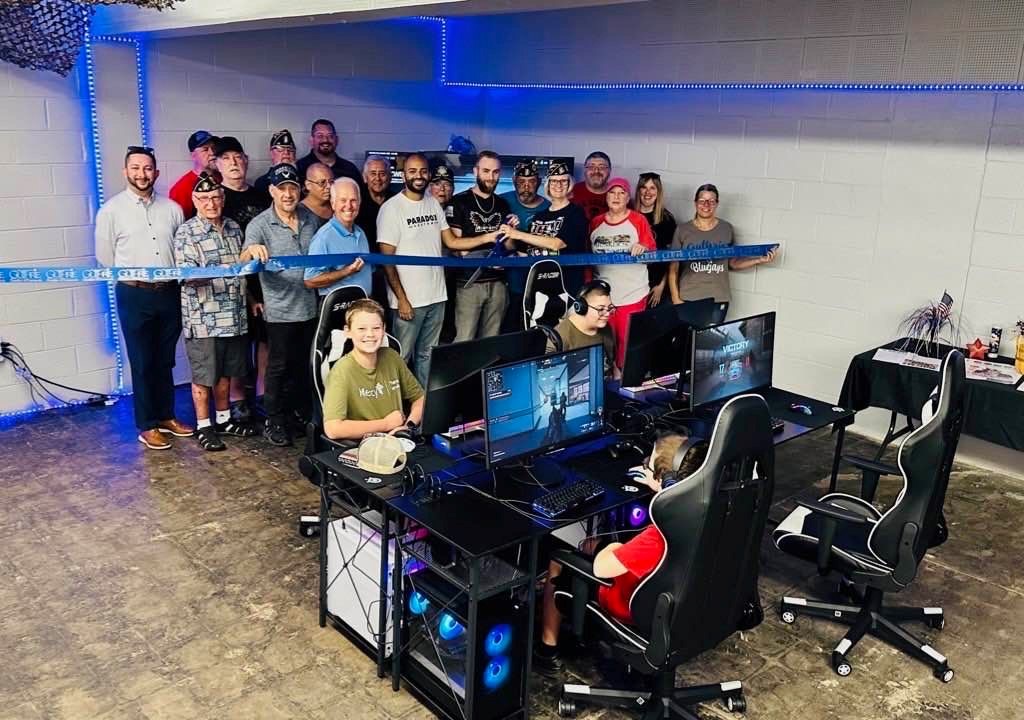 Group of people gathered in a gaming room.