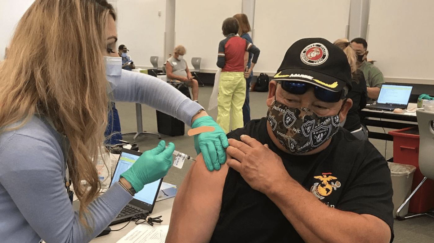 Clinical staff providing a vaccine to a Veteran.