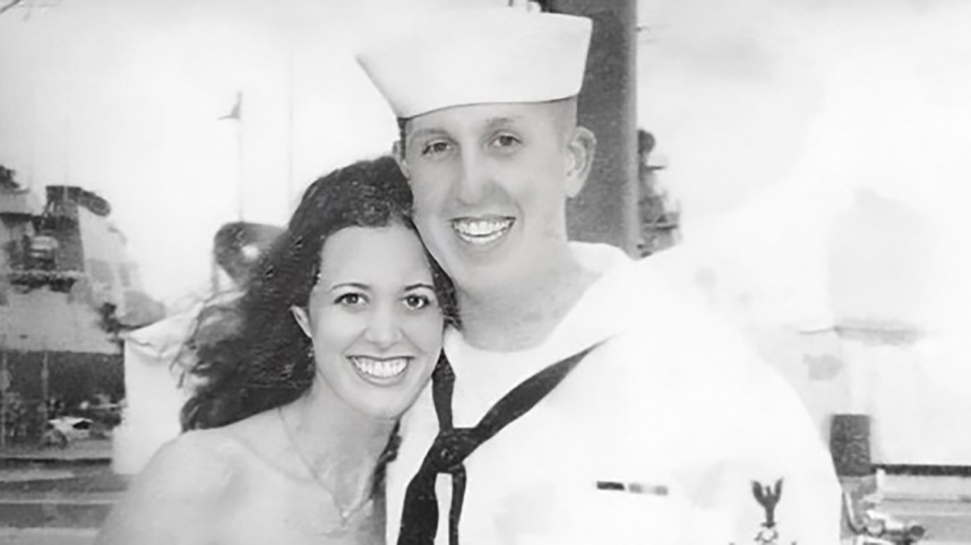 Black and white photo of Ron Haskell, U.S. Navy Veteran, next to his wife at the Norfolk Naval Base. exposure-informed care