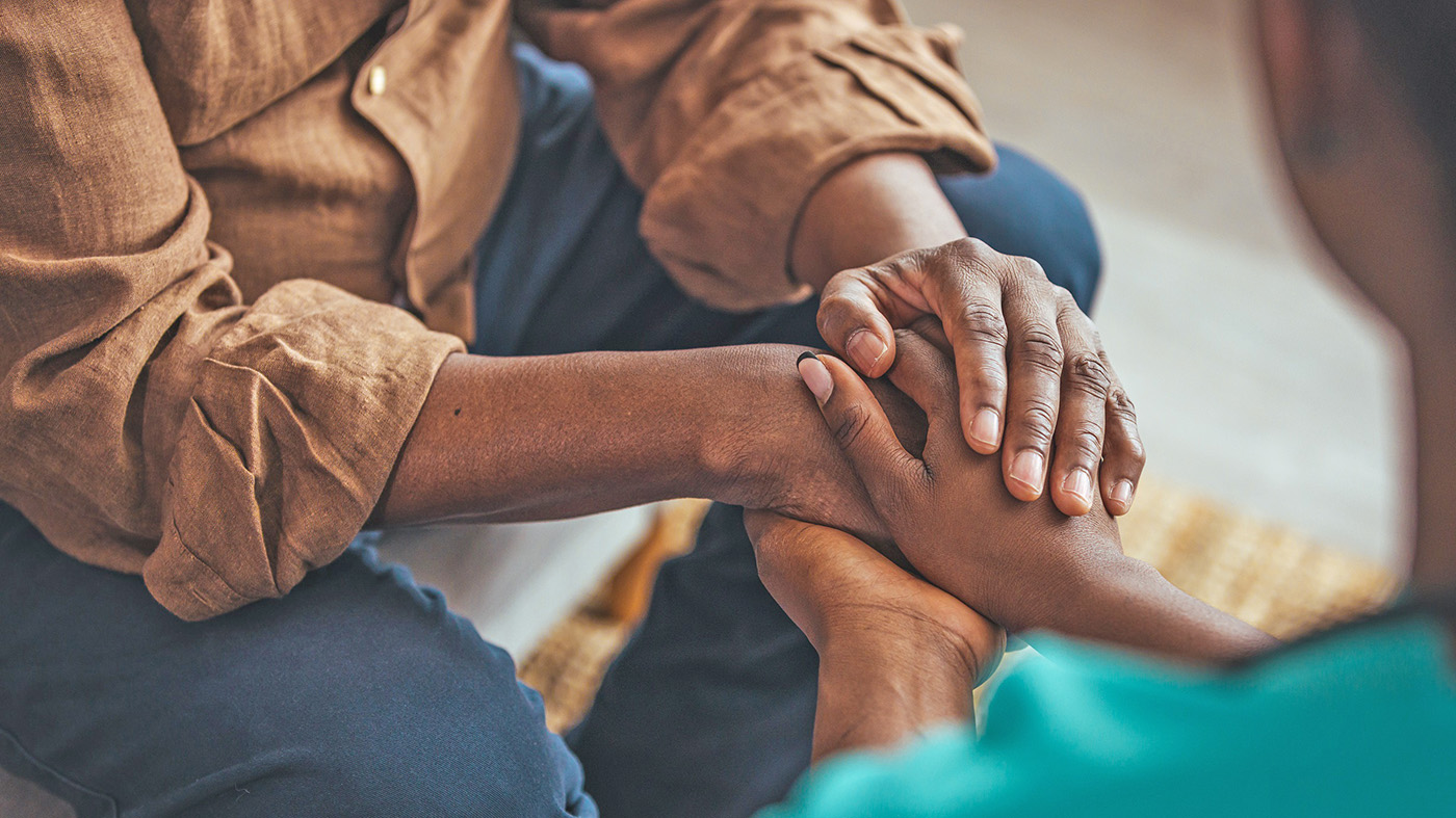 Person holding hands; suicide loss