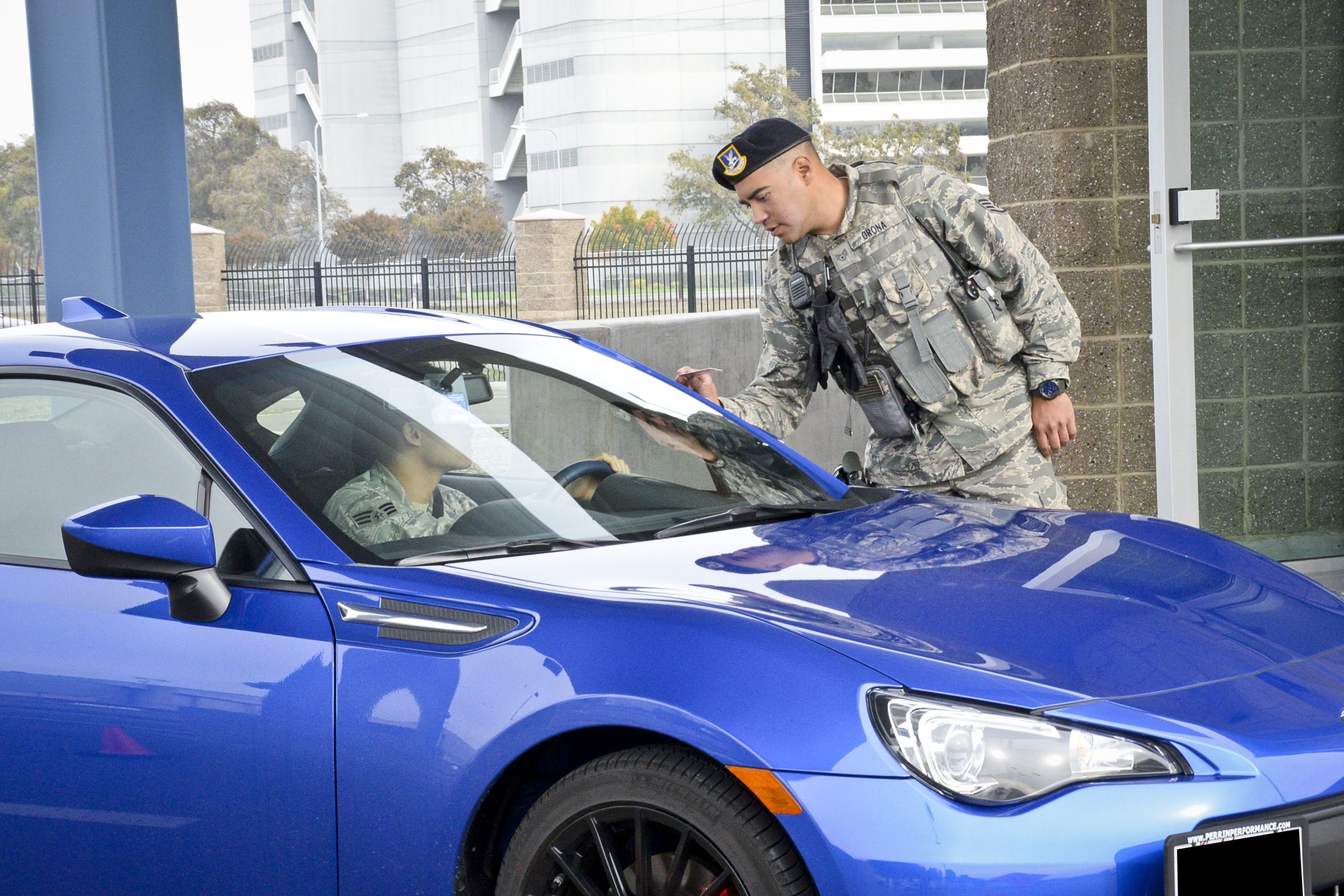 DOD Installation Access - Gate Guard checks ID's at base entrance