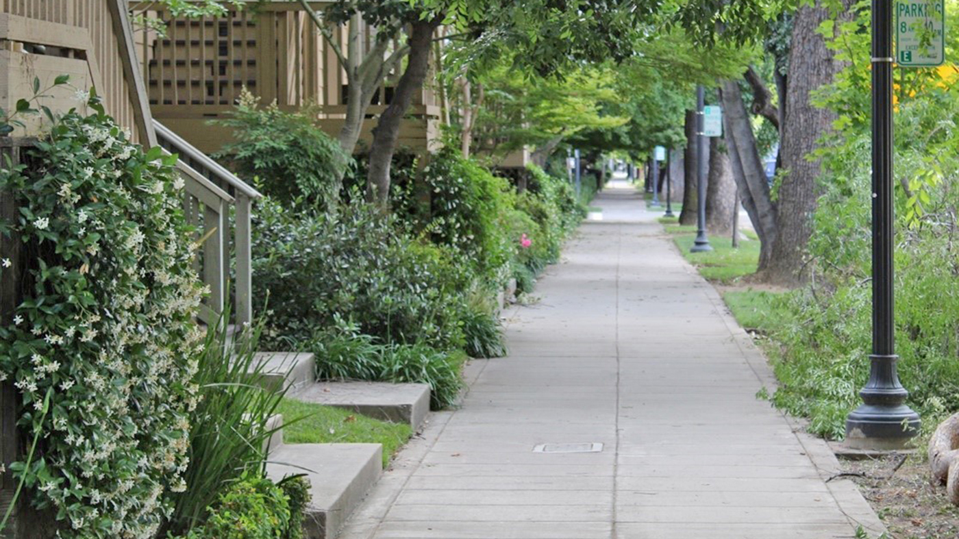 A sidewalk in a housing area