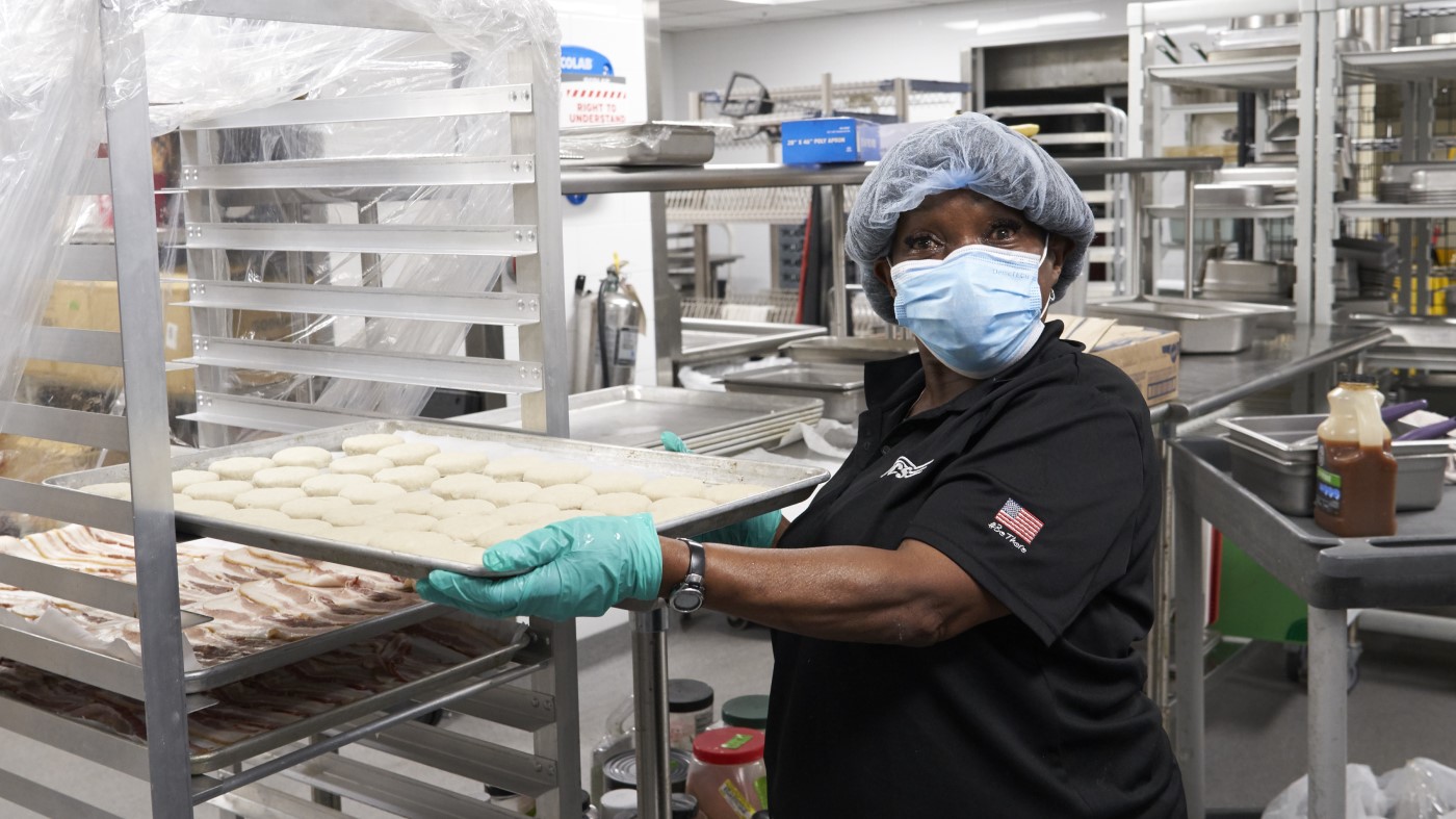 A VA food service worker prepares meals for distribution at Thanksgiving.